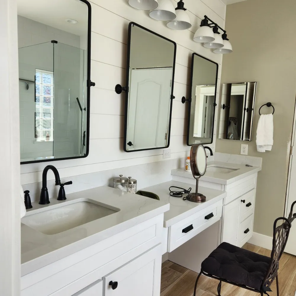 Modern primary bathroom remodel with neutral tile and custom vanity