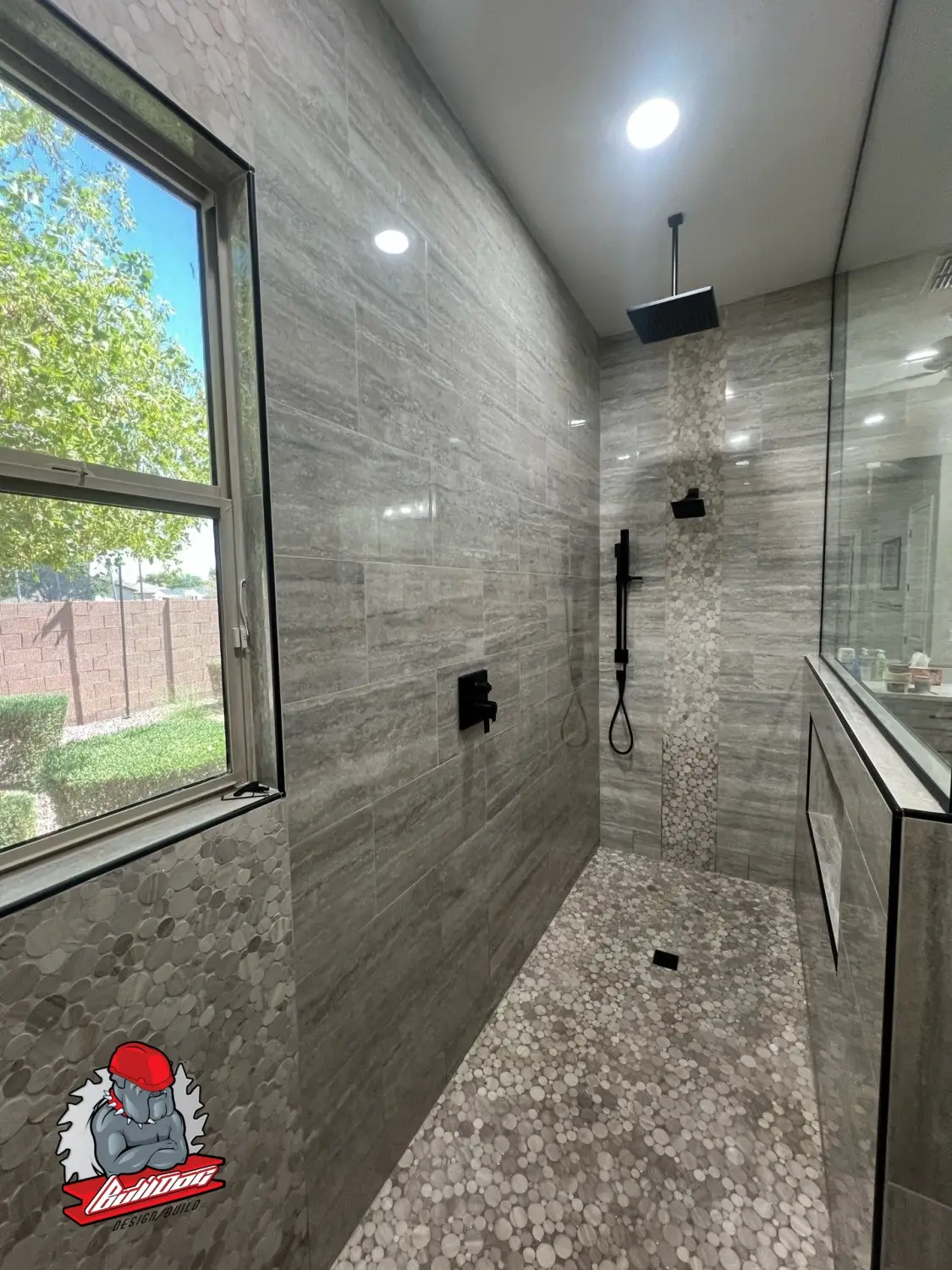 Spa-style walk-in shower finished in stone tile