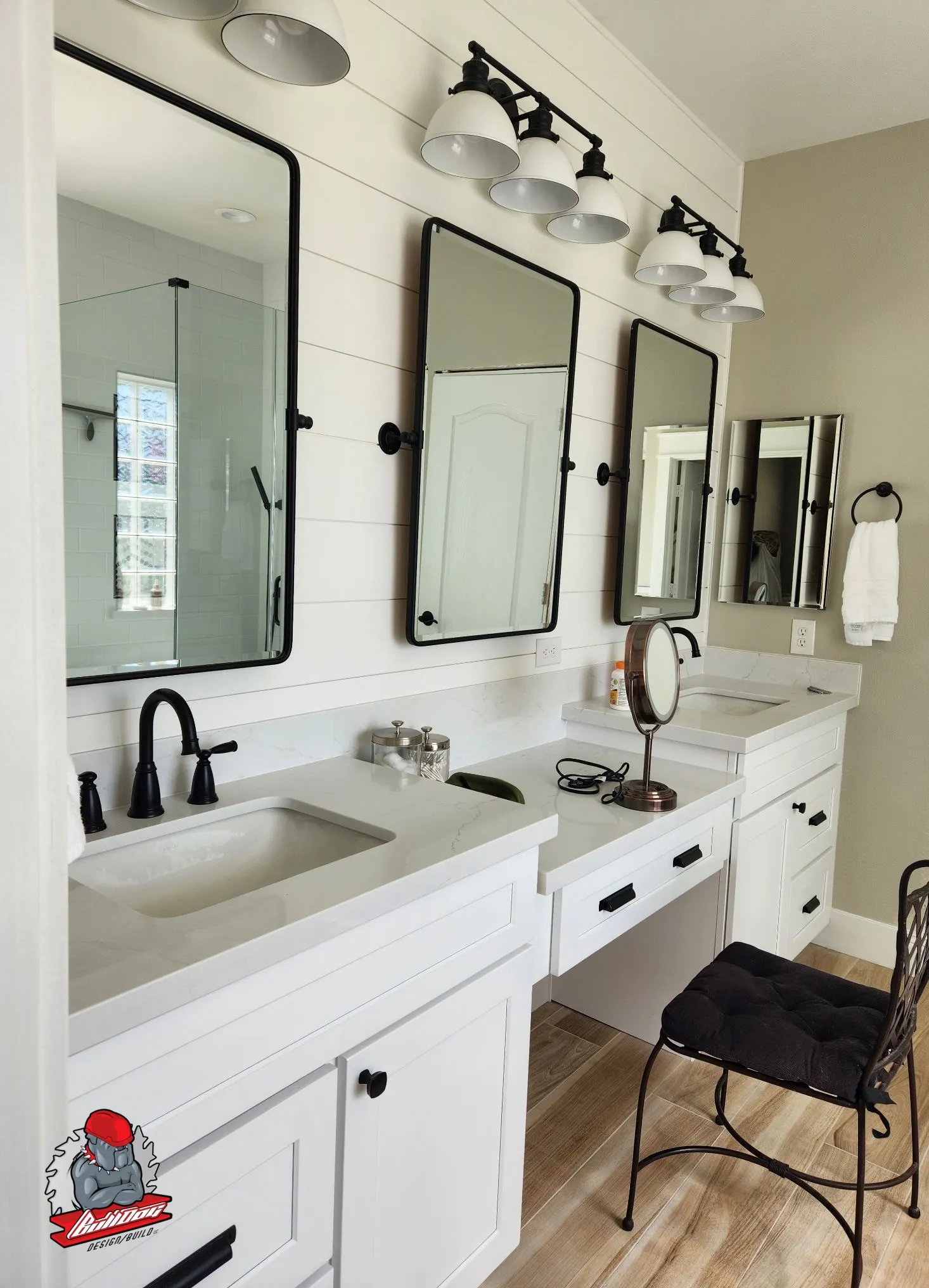 Bathroom double vanity with white cabinetry, quartz tops and black pivot mirrors